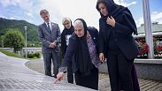 Nusrat Ghani walks with  Munira Subasic next to the momument with the names of Srebrenica genocide victims in Potocari, Bosnia, Wednesday, May 22, 2024.