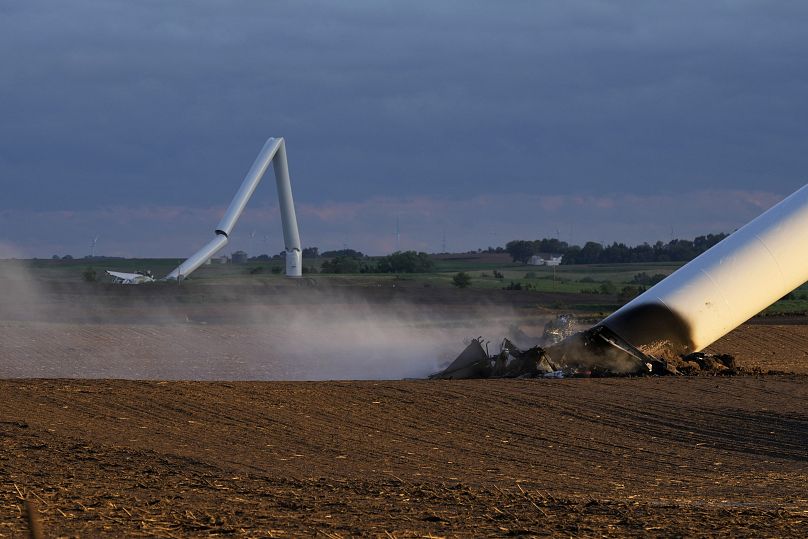 The remains of two tornado-damaged wind turbine touch the ground in a field, Tuesday, May 21, 2024, near Prescott, Iowa.
