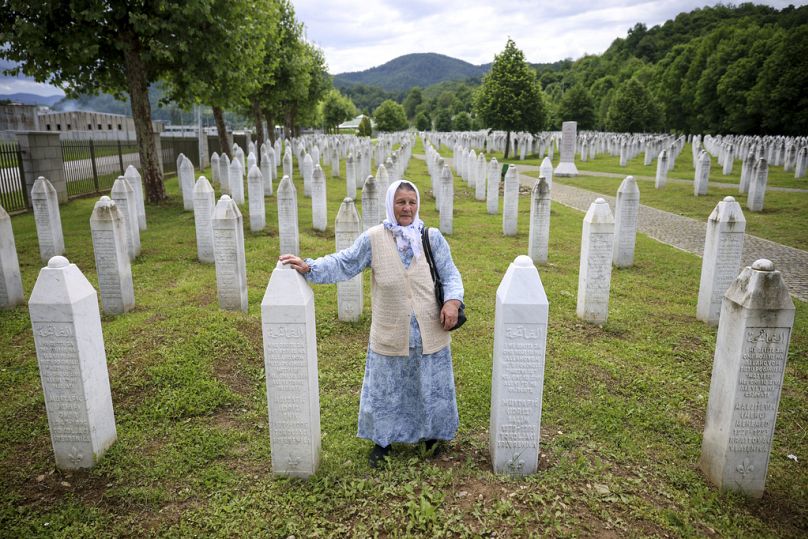 Şefika Mustafiç, Srebrenitsa soykırımının kurbanları olan iki oğlunun mezarlarının yanında yas tutuyor