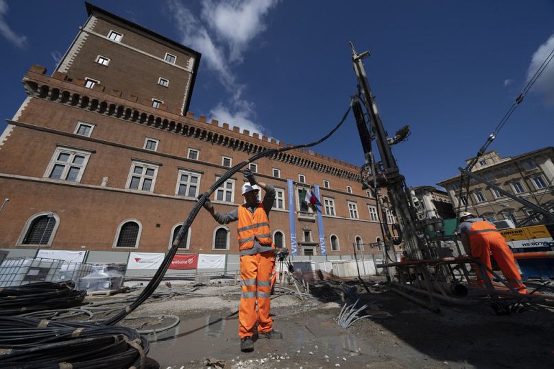 Workers inject reactive chemicals to consolidate the construction site in Piazza Venezia in central Rome, May 23, 2024.