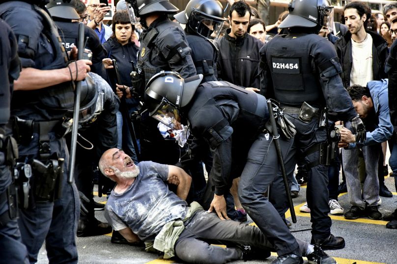 Police and demonstrators clash during a protest outside the Park Guell in Barcelona, Spain, 23 May 202.