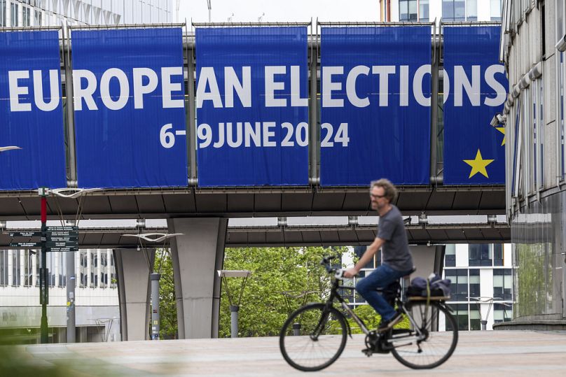 A man rides his bicycle outside the European Parliament, May 2024