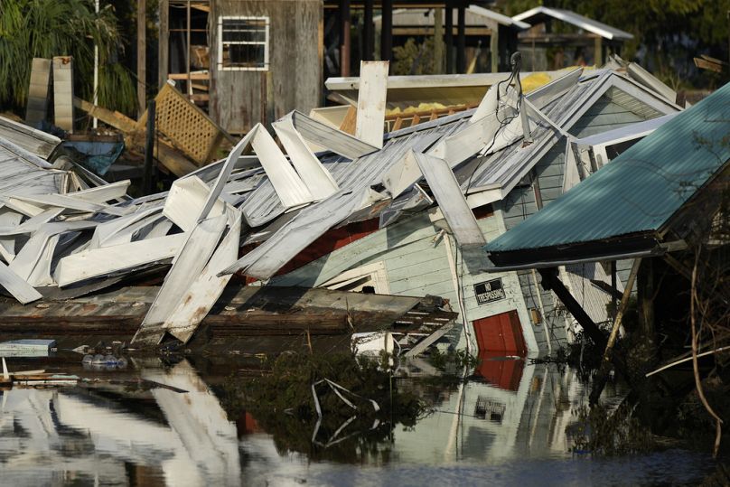 A home which came off its blocks sits partially submerged in a canal, in Florida after Hurricane Idalia.