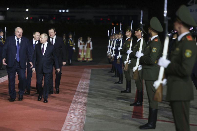Russian President Vladimir Putin (right) listens to Belarusian President Alexander Lukashenko at his arrival at the international airport in Minsk, Belarus, May 23, 2024.