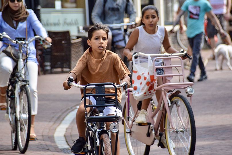 Children in Leiden take to the roads on their bikes.