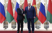 Russian President Vladimir Putin, left, and Belarusian President Alexander Lukashenko shake hands during a welcome ceremony at the Palace of Independence in Minsk, Belarus.