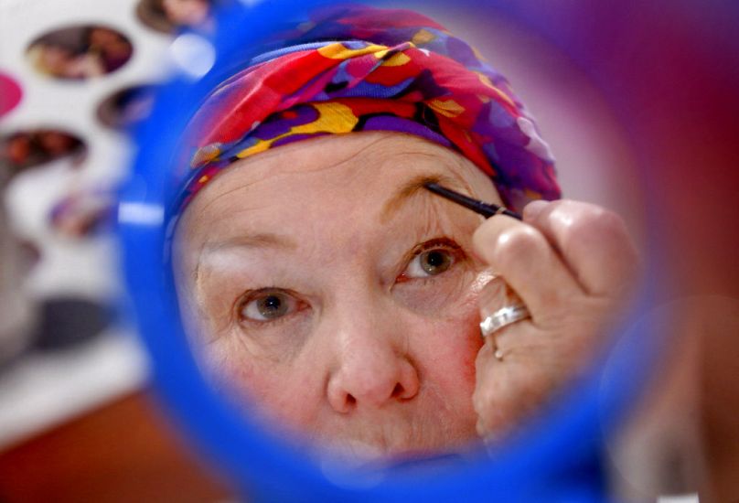 A woman uses a eyebrow brush during a "Look Good Feel Better" session at the Valley Health Cancer Center in Winchester VA, August 2018