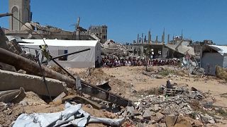 In the southern city of Khan Younis in the Gaza Strip, dozens of people attended Friday prayers near the destroyed Islam Mosque. 