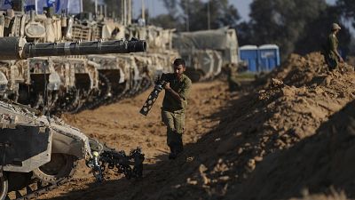 Un soldat israélien travaille sur un char près de la frontière de Gaza dans le sud d'Israël, le 24 mai 2024.