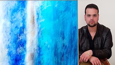 Artist Giovanni Guida with the work "Vital breath, in the blue of the sky"