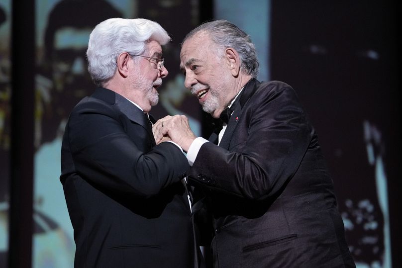 George Lucas (left) receives an honorary Palme d'Or and a hug from Francis Ford Coppola