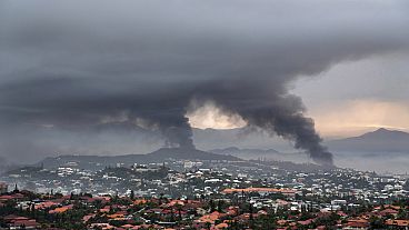 Smoke rises during protests in Noumea, New Caledonia, Wednesday May 15, 2024.