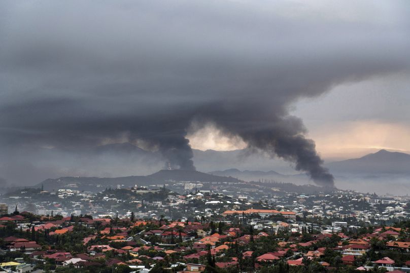 FILE - Smoke rises during protests in Noumea, New Caledonia, Wednesday May 15, 2024.