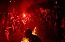 Demonstrators burn fire during a protest against Israeli Prime Minister Benjamin Netanyahu's government, and calling for the release of hostages held in the Gaza Strip by the 