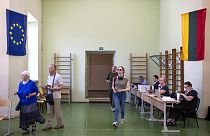 Lithuania's President Gitanas Nauseda, a presidential candidate, prepares to cast his ballot at a polling station during the advance presidential elections