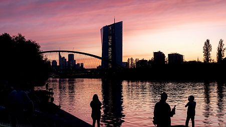The sun sets behind the European Central Bank in Frankfurt, Germany.