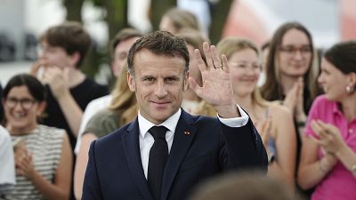 French President Emmanuel Macron waves as he visits the democracy festival to mark the 75th anniversary, near Berlin, ahead of their three-day state visit to Germany, 26/05/24