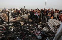 Palestinians look at the destruction after an Israeli strike where displaced people were staying in Rafah, Gaza Strip, Monday, May 27, 2024