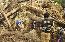 Villagers search amongst the debris from a landslide in the village of Yambali in the Highlands of Papua New Guinea, Monday, May 27, 2024.