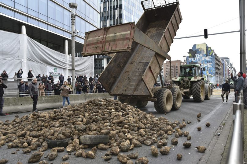 FILE - Protesting farmers dump a load of produce onto a main boulevard during a demonstration outside the European Council building in Brussels, on March 26, 2024.
