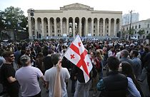 FILE - Demonstrators gather outside the parliament building in Tbilisi, Georgia, on Wednesday, April 17, 2024, to protest against "the Russian law" similar to a law that Russi
