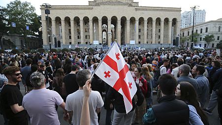 FILE - Demonstrators gather outside the parliament building in Tbilisi, Georgia, on Wednesday, April 17, 2024, to protest against "the Russian law" similar to a law that Russi