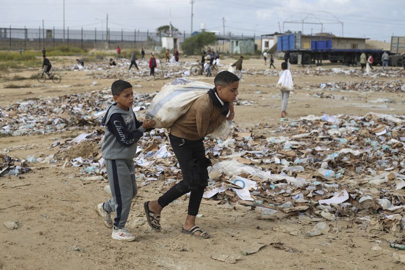Topladıkları plastik şişelere su dolduran Gazzeli çocuklar, kaldıkları çadıra dönerken