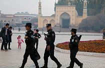 عبور ماموران پلیس از مقابل مسجدی در سین‌کیانگ چین