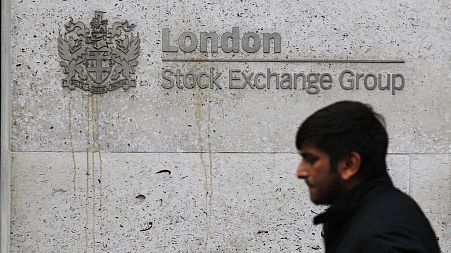 A man walks past London's Stock Exchange, in London's City financial district, Thursday, Nov. 3, 2011. 