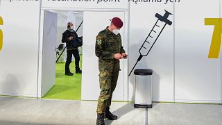 A soldier of the German Armed Forces Bundeswehr stands inside a new vaccination centre at the former Tempelhof airport in Berlin, Germany.