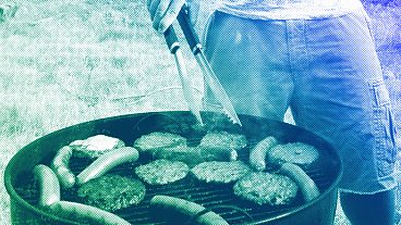 A person grills hamburgers and hot dogs in Arlington, VA, July 2012