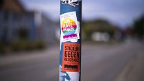 A sticker against Nazis and racism is displayed on a lamp pole near a school in Burg (Spreewald), 18 July 2023