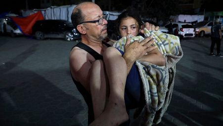 فلسطيني ينقل طفلة مصابة في قصف إسرائيلي على قطاع غزة إلى مستشفى الأقصى في دير البلح وسط قطاع غزة، في وقت متأخر من يوم الخميس 30 مايو/أيار 2024