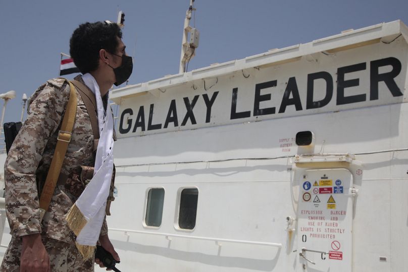 A Houthi soldier stands alert on board of the Israeli Galaxy ship which was seized by the Houthis, in the port of Saleef, near Hodeidah, Yemen, Sunday, May. 12, 2024. 