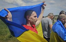 Ukrainian prisoners of war react after a prisoner exchange at an undisclosed location in Ukraine, 31 May 2024