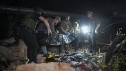 Police officers cover a dead body after the Russian missile attack hit an apartment building in Kharkiv, May, 31, 2024