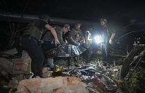 Police officers cover a dead body after the Russian missile attack hit an apartment building in Kharkiv, May, 31, 2024