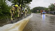 Firefighters work on a street flooded by the Günz in Ichenhausen, Germany, Saturday, June 1, 2024.  (Stefan Puchner/dpa via AP)