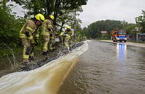 Firefighters work on a street flooded by the Günz in Ichenhausen, Germany, Saturday, June 1, 2024.  (Stefan Puchner/dpa via AP)