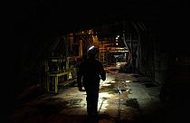 A worker walks along an internal corridor in a damaged DTEK thermal power plant after a Russian attack in Ukraine, Thursday, May 2, 2024.