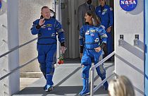 NASA astronauts Butch Wilmore, left, and Suni Williams share a laugh as they leave the building for a trip to launch pad at Space Launch Complex 41 Saturday, June 1, 2024.