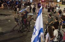 Israeli police remove a person protesting against Prime Minister Benjamin Netanyahu's government at a rally in Tel Aviv, June 1, 2024