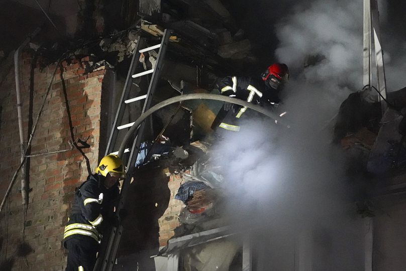 Firefighters put out a fire on an apartment building damaged in a Russian missile attack in Kharkiv, May, 31, 2024