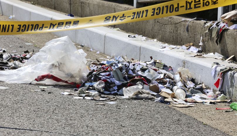 The trash from a balloon presumably sent by North Korea, is seen behind police tape in Incheon, 2 June 2024