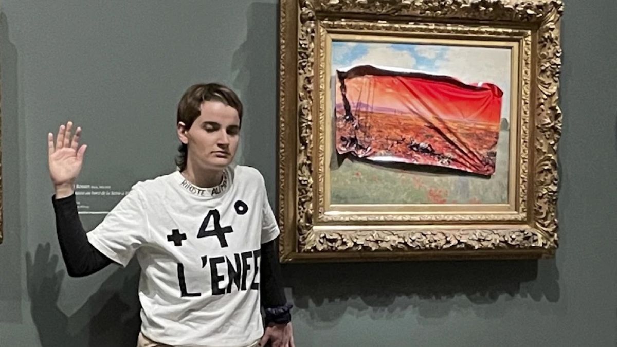 Climate protester sticks poster over Monet painting at the Musee D'Orsay thumbnail