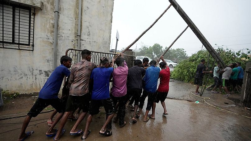  Workers restore electricity after cyclone biparjoy in Gujarat, India, Friday, June 16, 2023. 