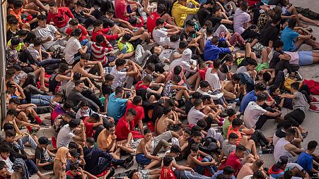 Unaccompanied minors who crossed into Spain are gathered outside temporary shelter in Ceuta, near the border of Morocco and Spain, Wednesday, 19 May, 2021.