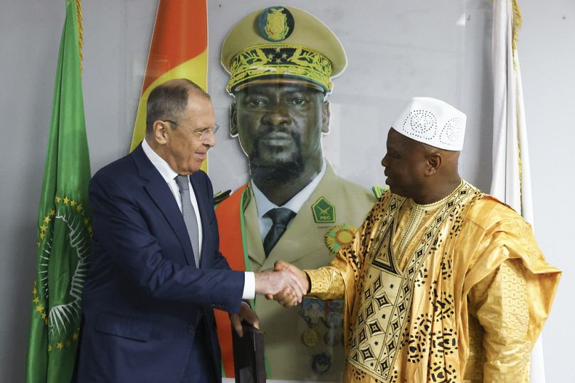 In this photo released by Russian Foreign Ministry Press Service, Russian Foreign Minister Sergey Lavrov, left, and Guinea's foreign minister Morissanda Kouyate shake hands ne