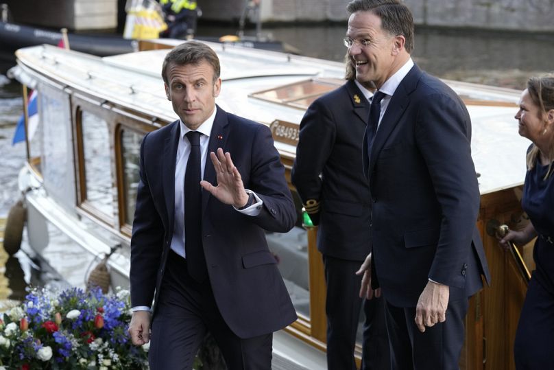 French President Emmanuel Macron, left, and then Dutch Prime Minister Mark Rutte arrive in Amsterdam, Netherlands, 202