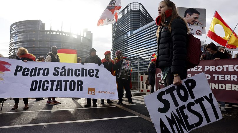 Des manifestants protestent contre le Premier ministre espagnol Pedro Sanchez et une loi d'amnistie potentielle devant le Parlement européen, mercredi 13 décembre 2023.